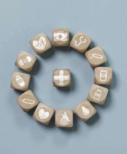 Wooden block cube which print screen health care and medical icons for healthy and wellness concept.